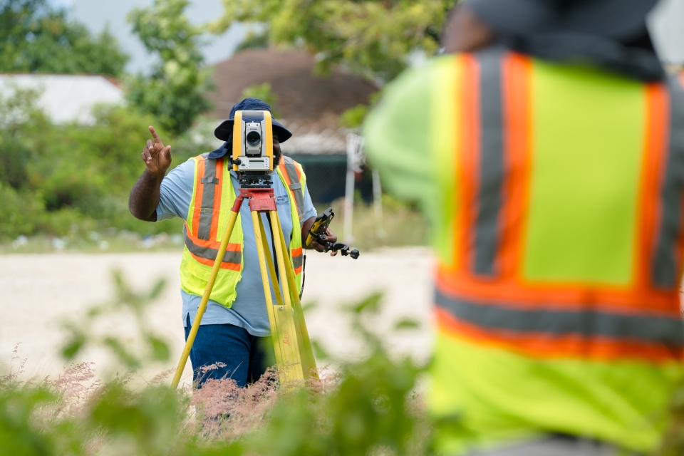 Cayman Islands Government Lands and Survey Department Land Surveyors in the field.