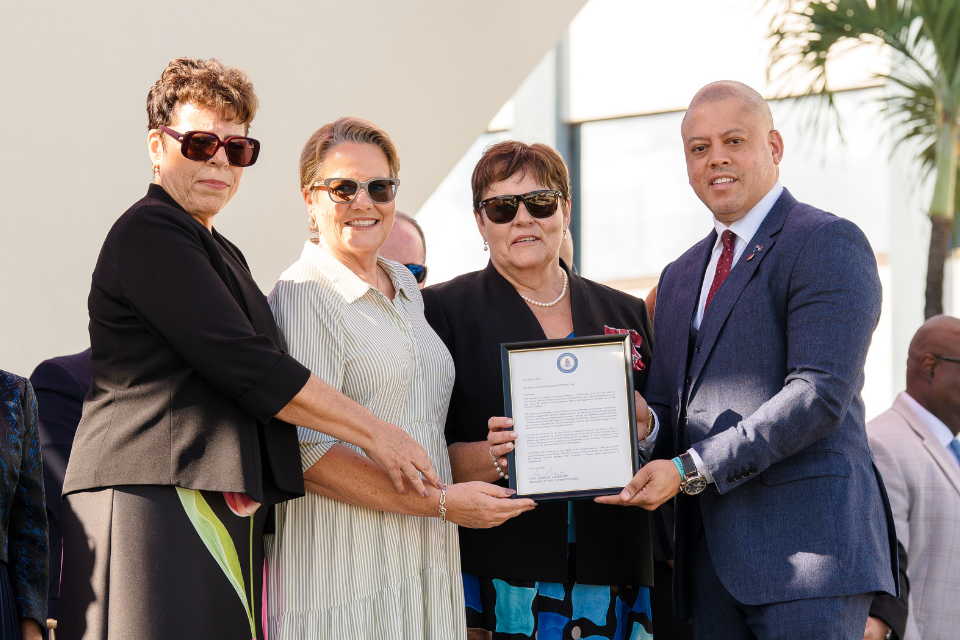 Judith Seymour, Janet Hislop and Gina Ebanks-Petrie, children of the late Honourable Benson O. Ebanks, OBE, receive Cabinet’s declaration from Premier André Ebanks recognising him as the country’s 15th national hero.