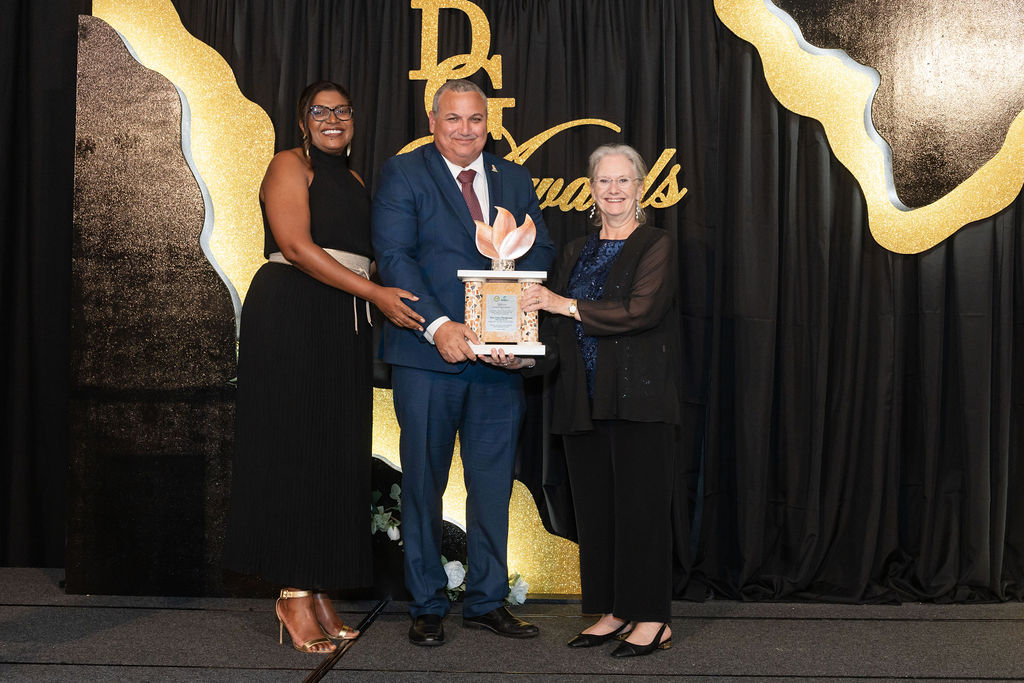 Deputy Governor Honourable Franz Manderson received a lifetime achievement award form Her Excellency The Governor Jane Owen (right) and Portfolio of the Civil Service Chief Officer Gloria McField-Nixon.